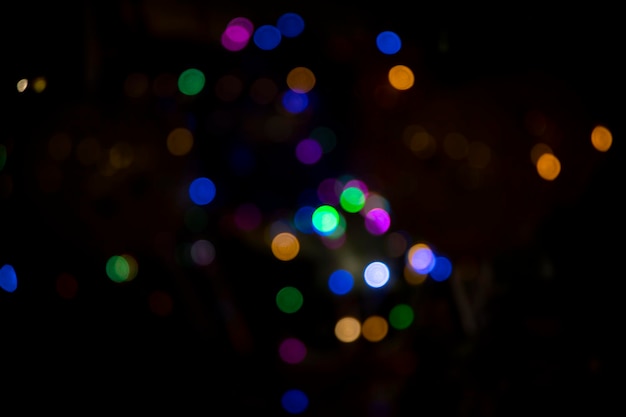 Abstract colorful bokeh light effects on the night black background texture