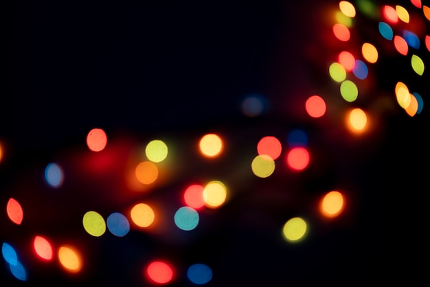 The abstract colorful bokeh lights of garland on the party celebration