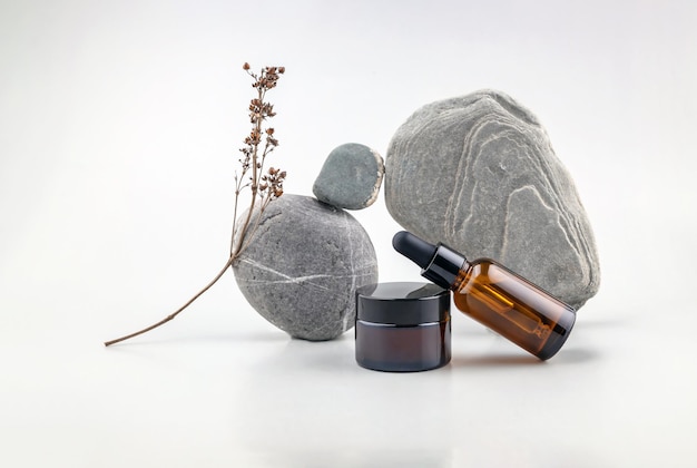 Abstract composition of balancing stones bottles for cosmetics and dried flowers