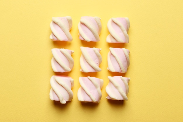 Abstract composition of marshmallows on a yellow background. Tov view