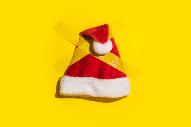 Abstract composition santa claus hat fixed with tape to the wall