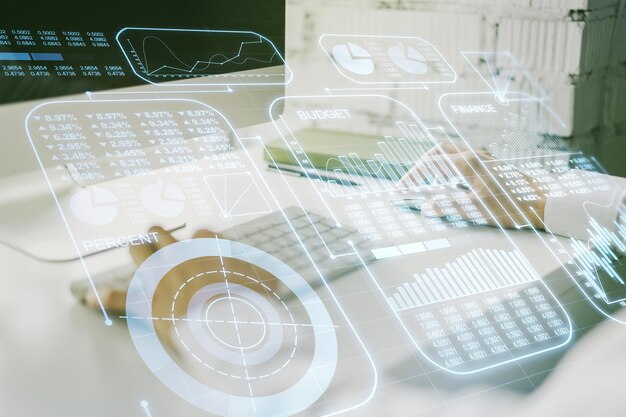 Abstract creative analytics data spreadsheet with hands typing on laptop on background analytics and analysis concept Multiexposure