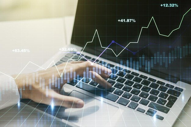 Photo abstract creative financial graph with hand typing on laptop on background financial and trading concept multiexposure