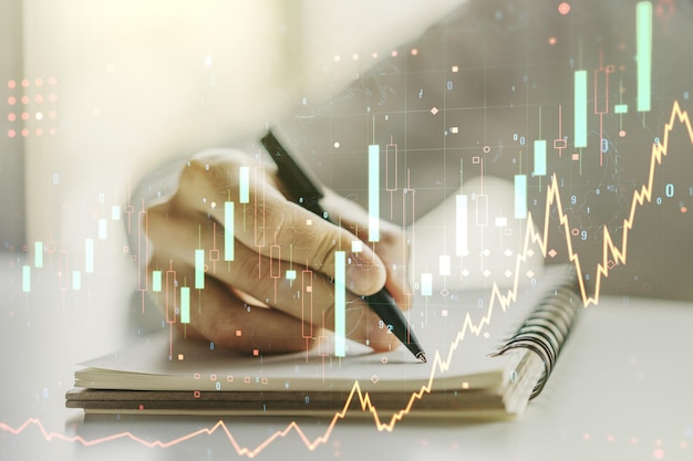 Abstract creative financial graph with hand writing in diary on background financial and trading concept Multiexposure