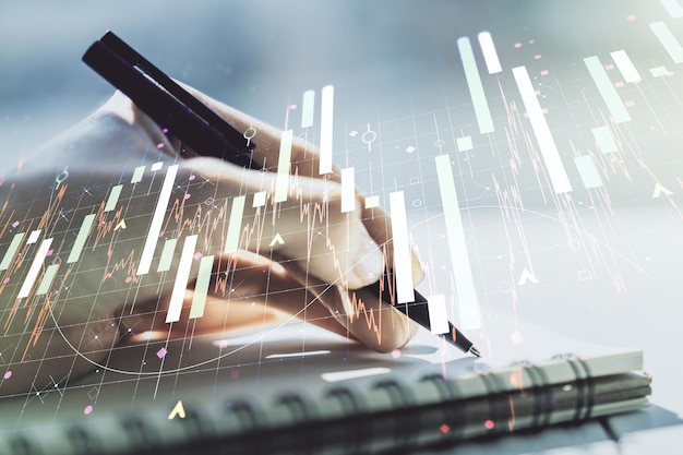 Abstract creative financial graph with hand writing in diary on background financial and trading concept Multiexposure