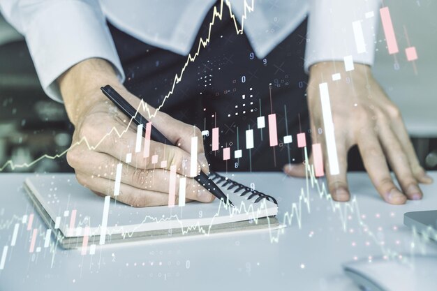 Abstract creative financial graph with hand writing in notebook on background forex and investment concept Multiexposure