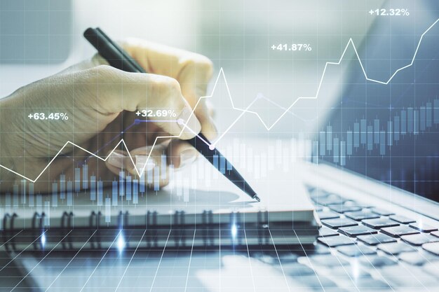 Abstract creative financial graph with hand writing in notebook on background forex and investment concept Multiexposure