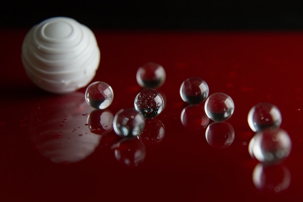 The abstract  crystal ball on red glossy floor background.