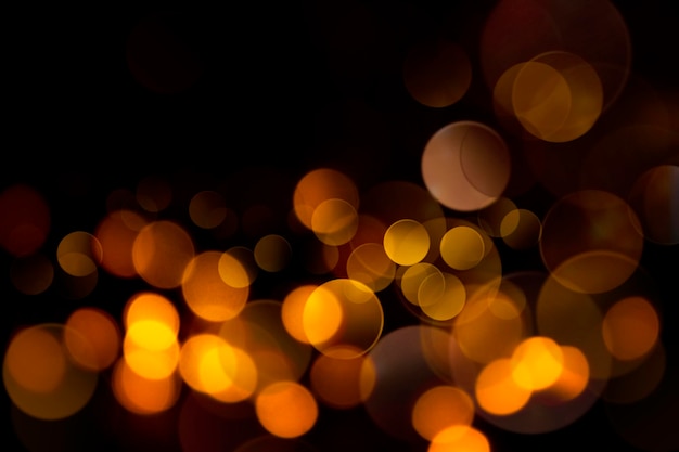 Abstract dark background with yellow bokeh closeup