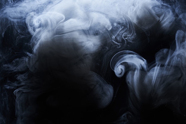 Photo abstract dark paint in water background. white smoke cloud motion on black, acrylic ink swirl splashes