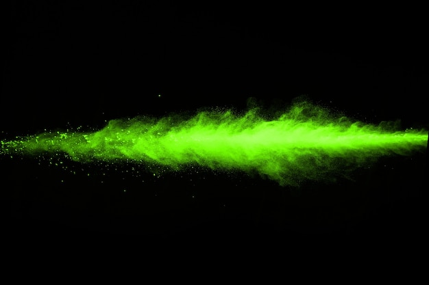 Abstract dust explosion frozen green on black background