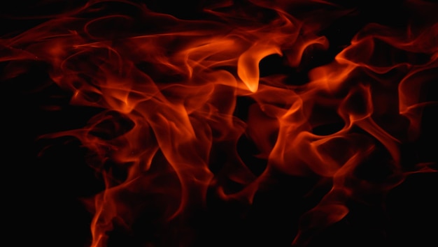 Photo abstract fire flame in fireplace texture for background beautiful bright orange flames flicker in the darkness of the night