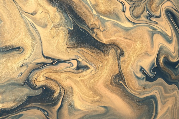抽象的な流体アートの背景ネイビーブルーと金色。液体大理石。ベージュのキラキラグラデーションのアクリル画。