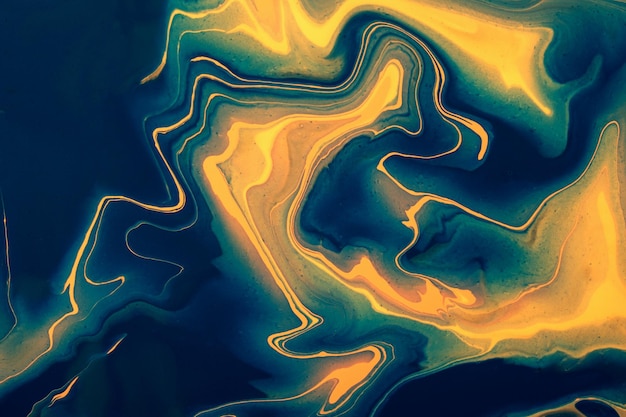 Abstract fluid art background navy blue and golden colors. Liquid marble. Acrylic painting with yellow gradient