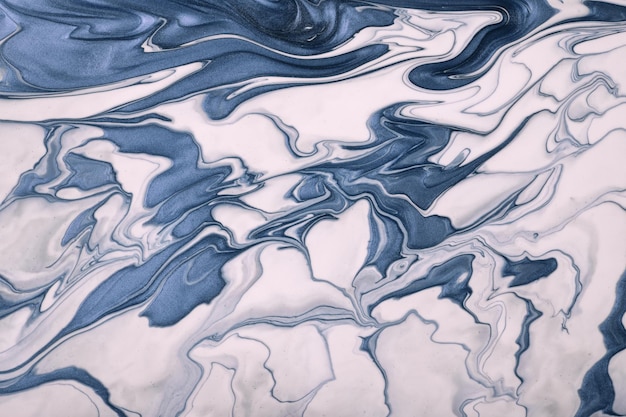 Abstract fluid art background navy blue and white colors. liquid marble. acrylic painting with swirl denim gradient.