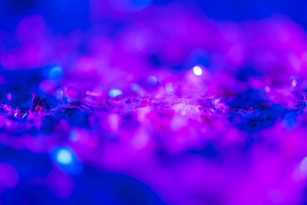 Abstract glowing background with ultra violet glitter and bokeh