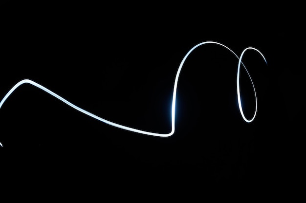 Abstract glowing signing line isolated in black background