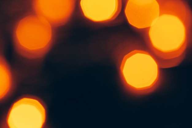 Abstract gold bokeh sparkle on dark background