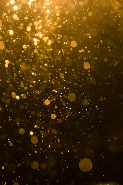 Abstract gold bokeh with black background