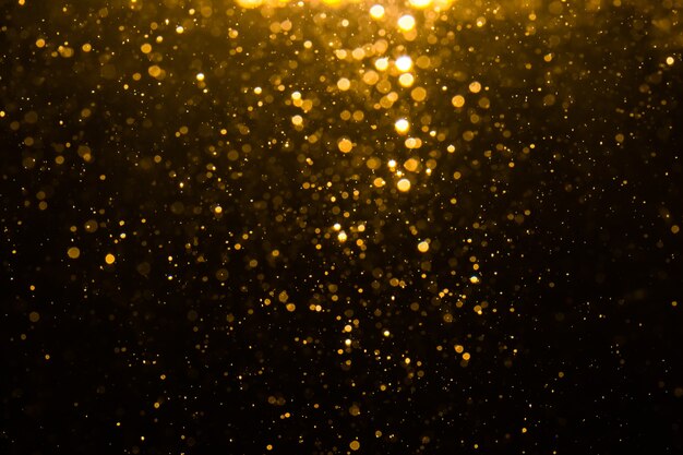 Abstract gold bokeh with black background