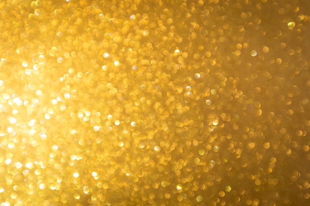 Sfocatura dello sfondo di natale festivo con glitter oro astratto con luce bokeh