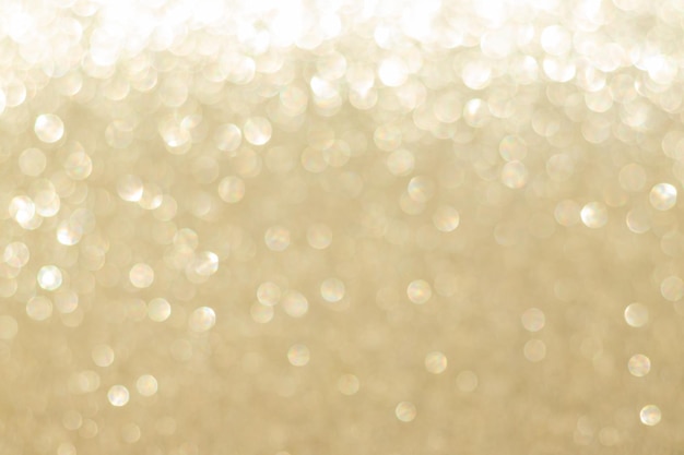 Photo abstract golden bokeh background, defocused blurry sparkles.