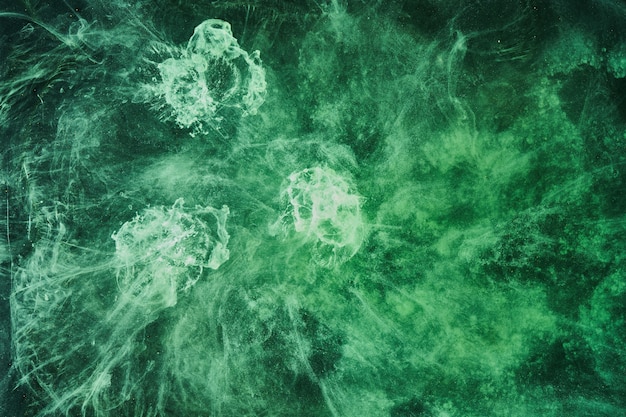 Abstract green color background. Swirling vibrant hookah smoke, underwater emerald ocean, dynamic paint in water