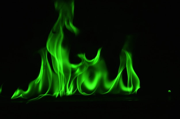 Abstract Green fire flames on black background