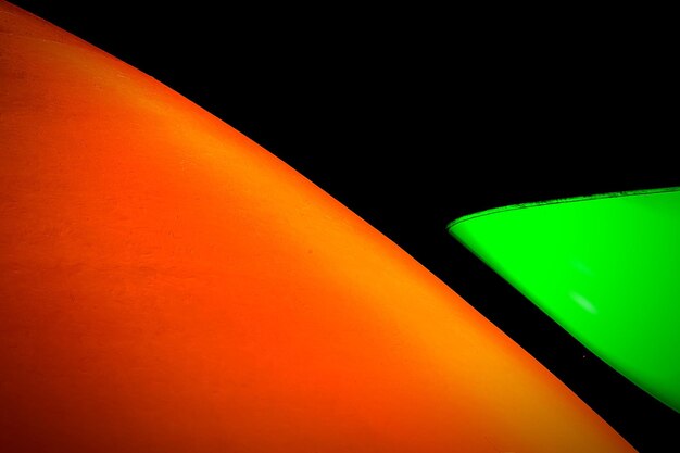 Abstract green and orange shape on black background