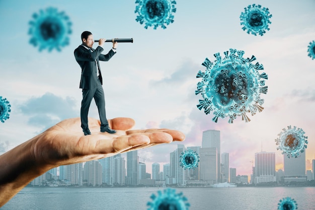 Abstract hand holding business man with telescope looking into the distant future on daylight city background with virus Pandemic epidemic coronavirus health and medicine concept