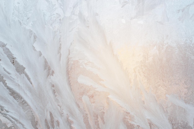 Abstract ice pattern on window glass Hoarfrost texture background on sunny winter day