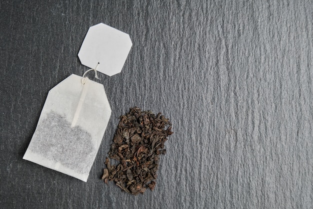 An abstract image of the contents of a bag of black tea against the background of a slate board.