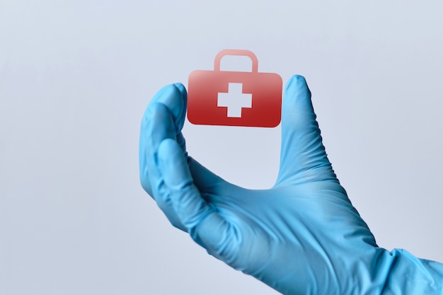 Abstract image of health care in a hand with doctor gloves.