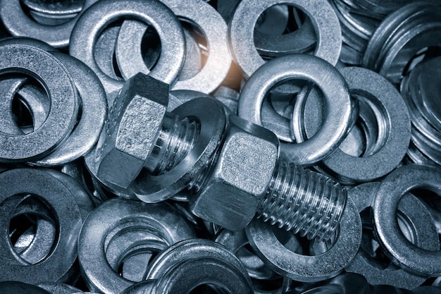 Abstract industrial textured metal background with many metal washers for bolts nuts and screws closeup