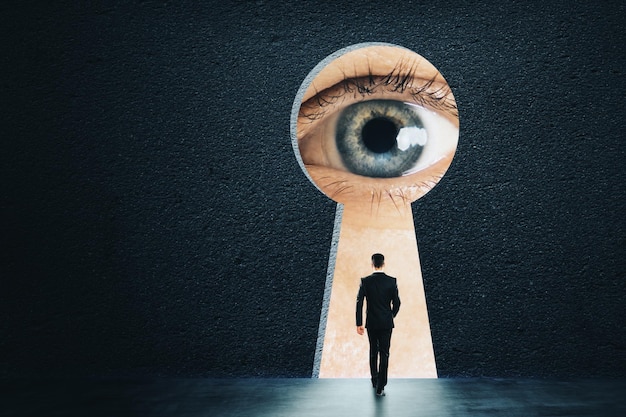 Photo abstract keyhole with businessman eye