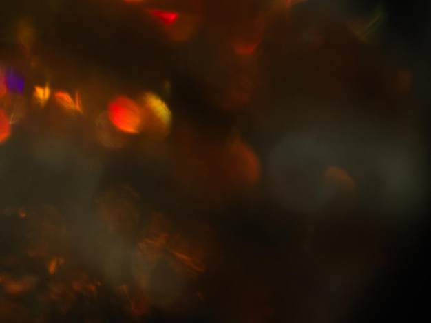 Foto abstract lens flare su sfondo nero arancione sfocato bokeh luci sfocate natale decorazione carta da parati festivo cerchi incandescente design