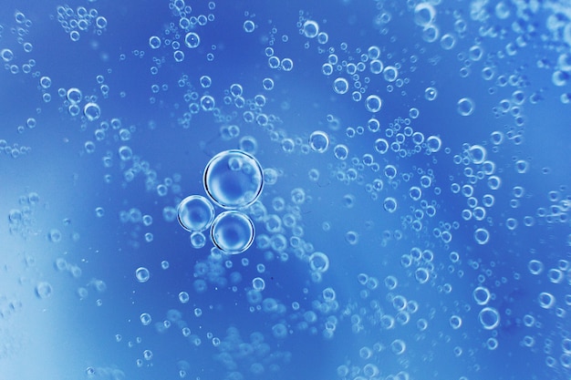 Abstract light blue background with oil circles  bubbles of water close up