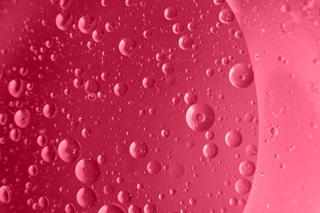 Abstract light viva magenta background with oil circles bubbles of water close up