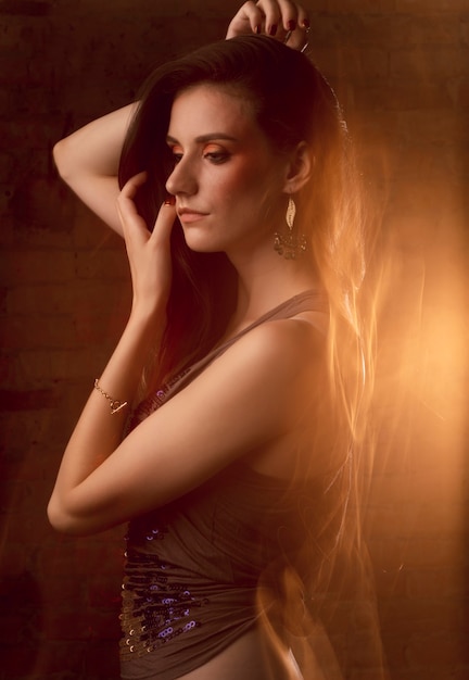 Abstract mixed lighting portrait of elegant brunette model at studio