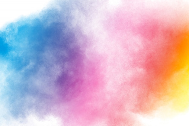 Abstract multi color powder explosion on white background.Freeze motion of dust particles splash.