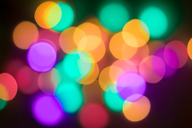 Abstract multi-colored bokeh on a black background. Defocused abstract lights christmas ba