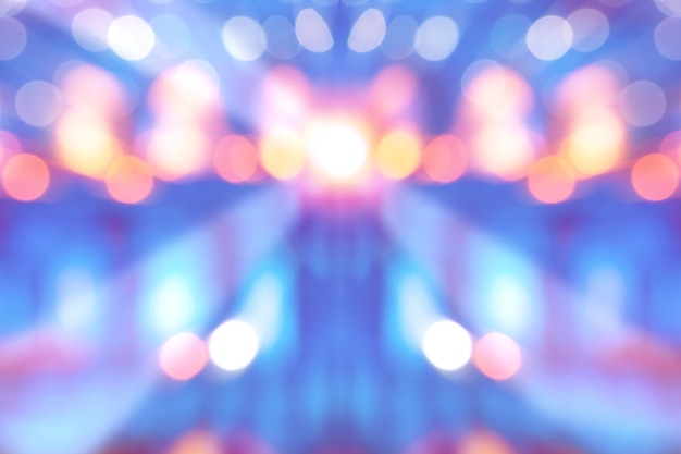 Abstract multi-colored light background with defocused bokeh light, the stage of the entertainment show