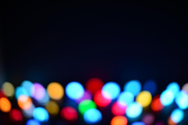 Abstract multicolor festive christmas lights on a black background soft focus