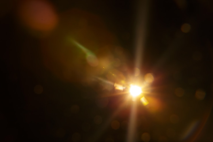 Photo abstract natural sun flare on the black background.