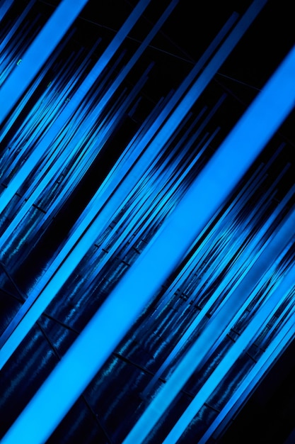 Abstract neon light poles angled in blue