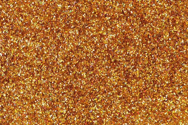 Abstract orange gold glitter background on macro