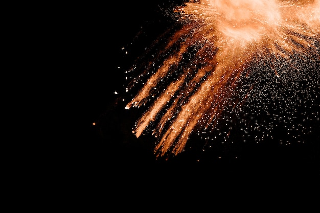 abstract orange powder explosion on black background