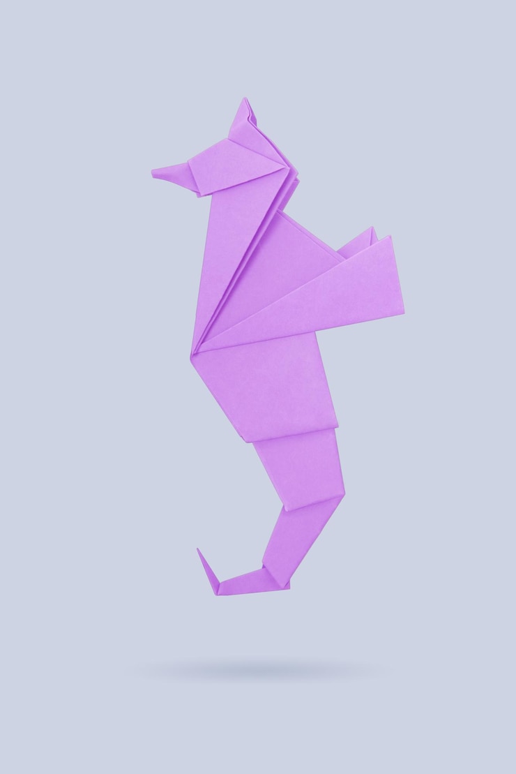 Photo abstract origami sea horse isolated on a gray backgrounds