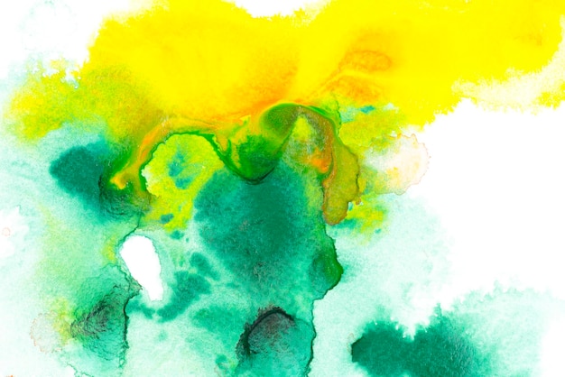 Abstract painting with green and yellow watercolor paint blots on white