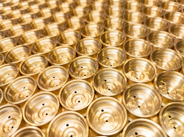 An abstract perspective industrial closeup background of shiny brass metal threaded hexagonal fitting parts